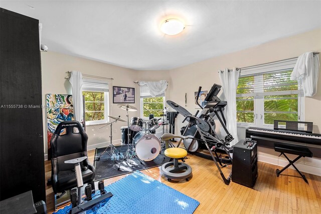 workout room with light hardwood / wood-style flooring