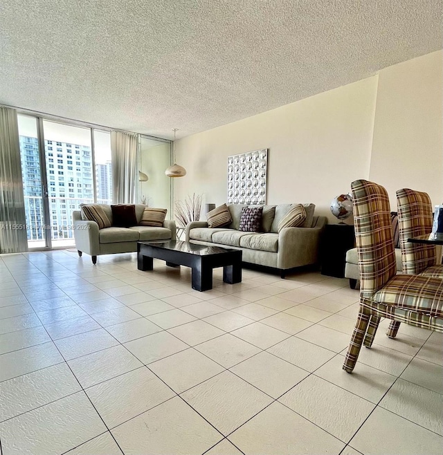 living room with floor to ceiling windows, light tile floors, and a textured ceiling