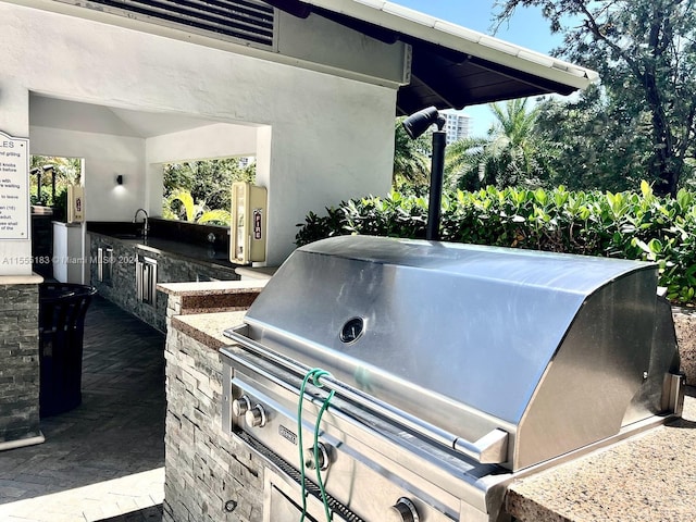 view of patio featuring area for grilling, grilling area, and sink