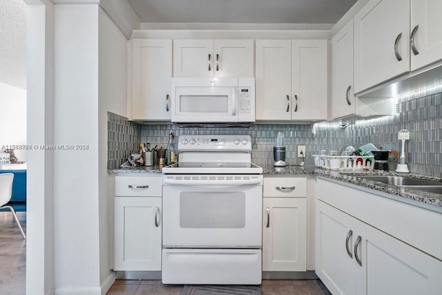 kitchen featuring white cabinets, backsplash, light stone countertops, and white appliances