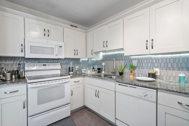 kitchen featuring white appliances, white cabinetry, backsplash, and sink