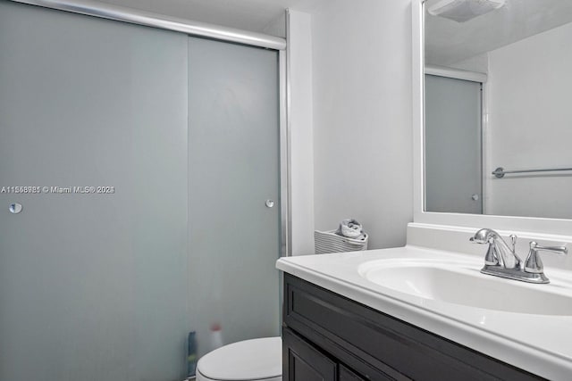 bathroom featuring vanity and toilet