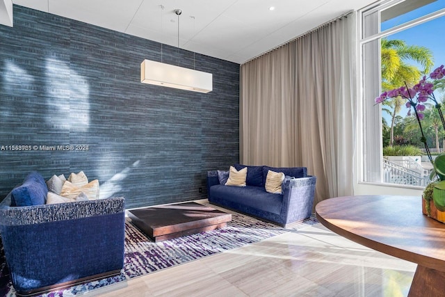 sitting room featuring dark tile flooring and a wall unit AC