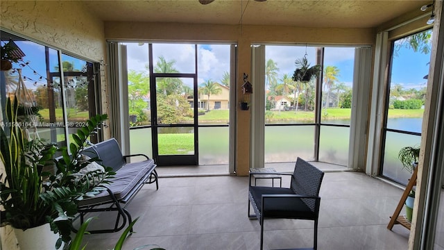 sunroom / solarium featuring a water view and a healthy amount of sunlight