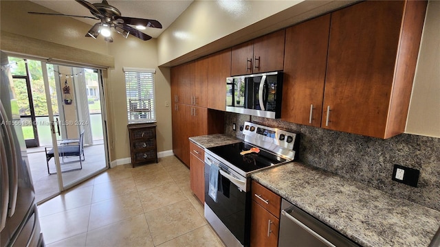 kitchen featuring light tile patterned floors, backsplash, stainless steel appliances, ceiling fan, and light stone counters