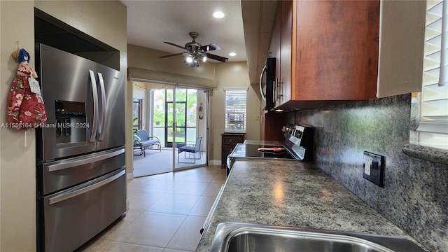 kitchen featuring light tile patterned floors, stainless steel appliances, sink, ceiling fan, and decorative backsplash