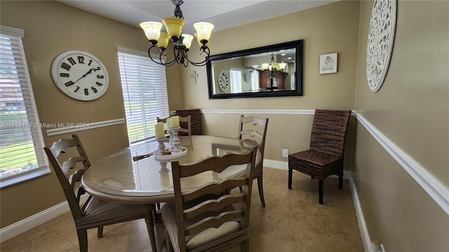 dining space featuring a wealth of natural light, an inviting chandelier, and tile patterned floors