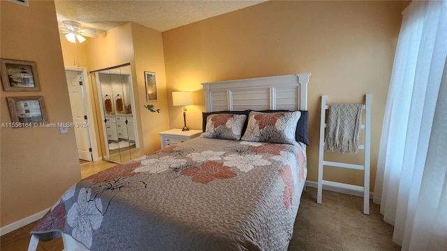 tiled bedroom featuring a textured ceiling and ceiling fan