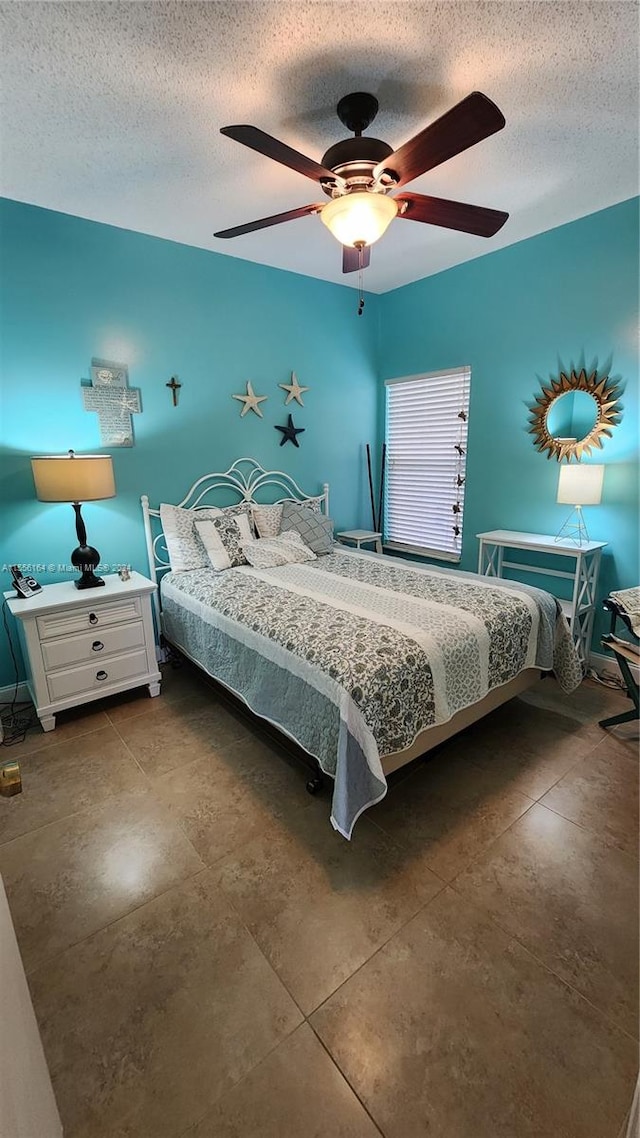 bedroom with a textured ceiling and ceiling fan