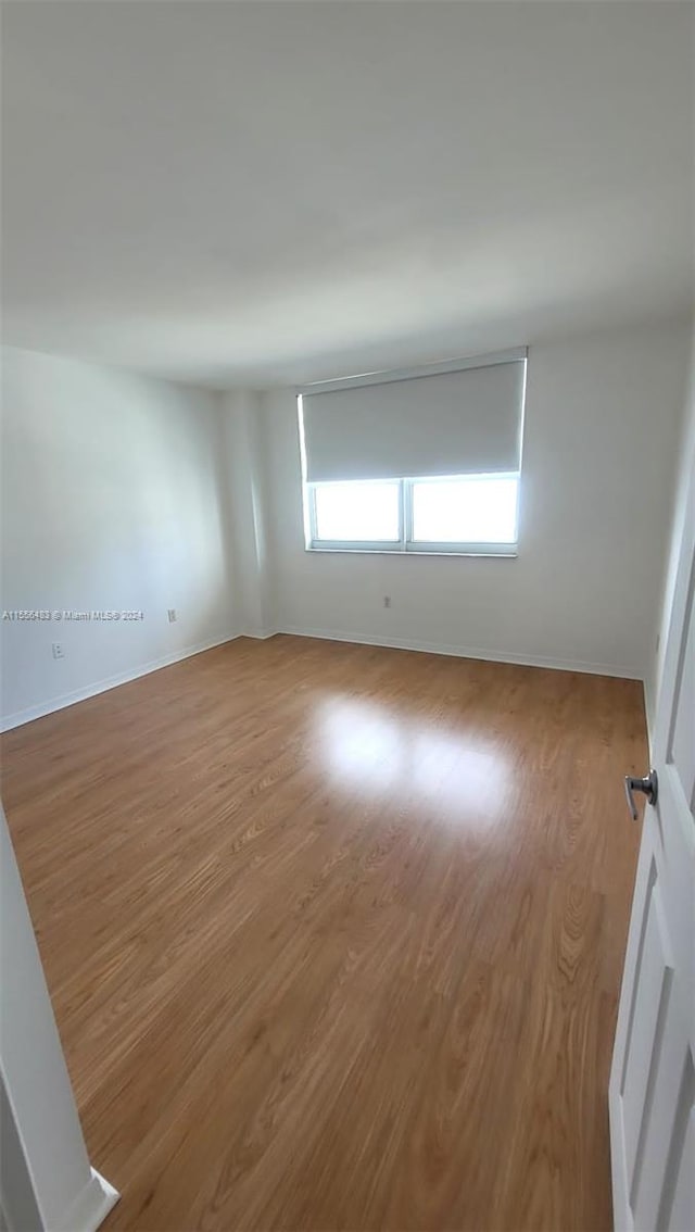 unfurnished room featuring hardwood / wood-style floors