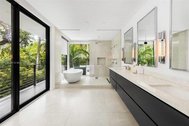 bathroom with tile patterned flooring, vanity, and plus walk in shower