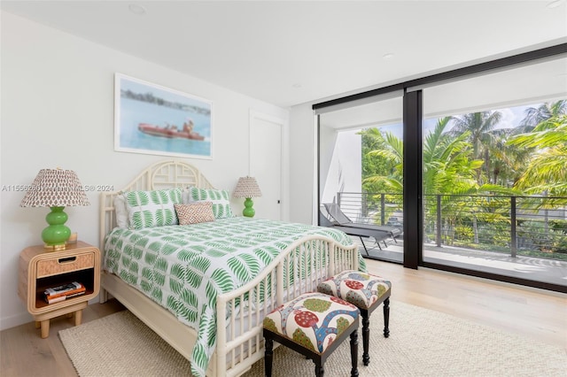 bedroom featuring light wood-type flooring and access to exterior