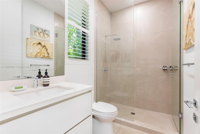 bathroom featuring vanity, toilet, walk in shower, and tile patterned flooring