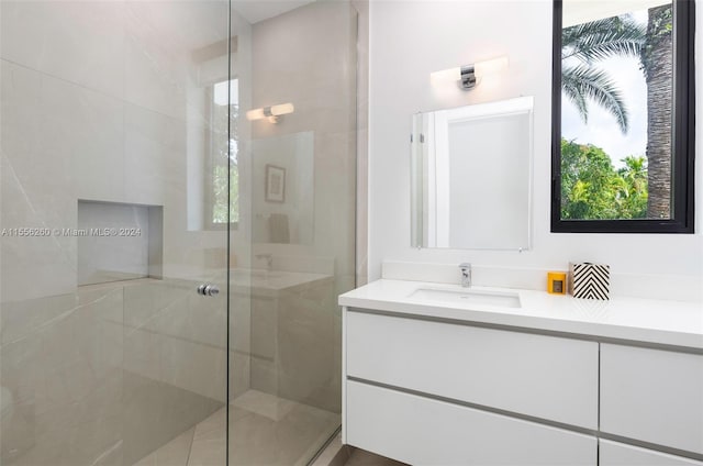 bathroom with an enclosed shower, plenty of natural light, and vanity