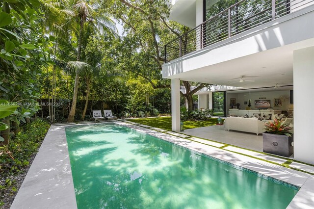 view of pool with ceiling fan and a patio area