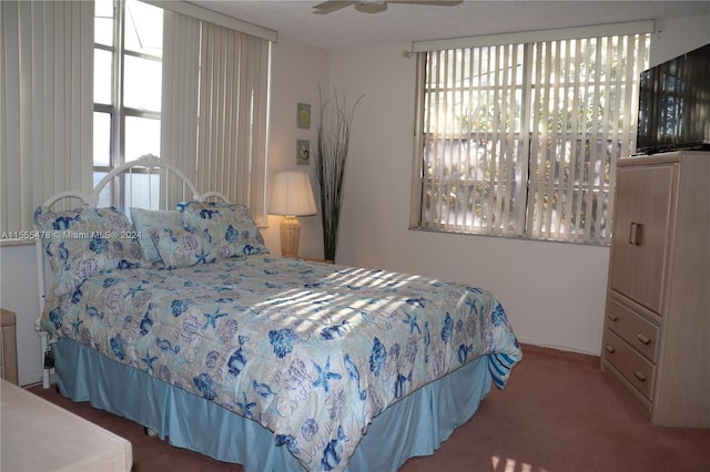 bedroom with multiple windows, ceiling fan, and carpet