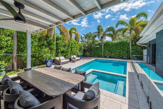 view of pool with outdoor lounge area, a patio area, and ceiling fan