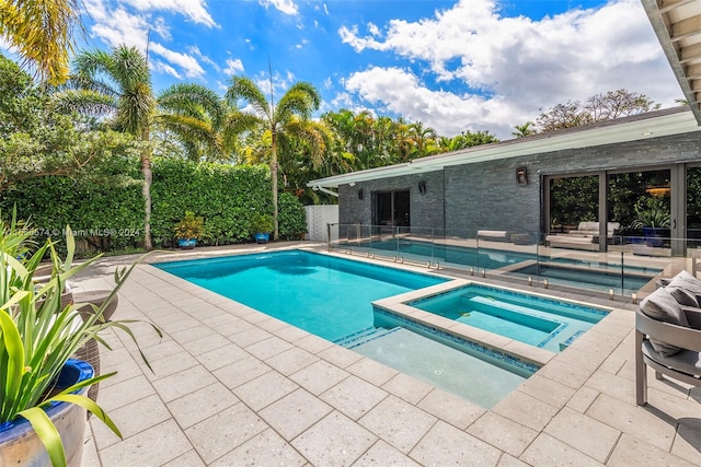 view of swimming pool with an in ground hot tub and a patio area