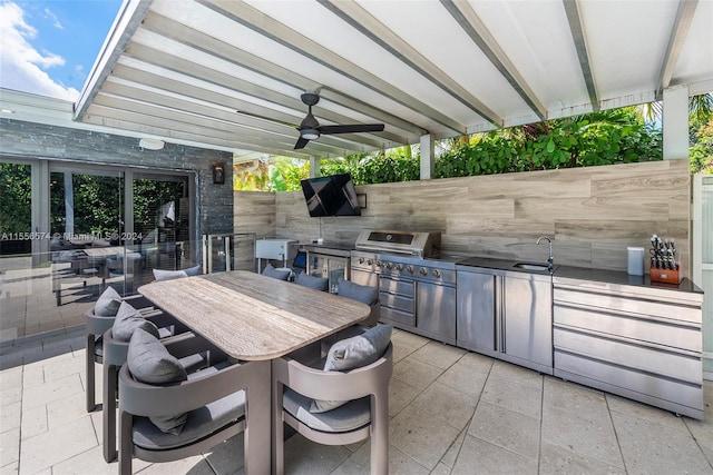 view of patio with area for grilling, sink, and ceiling fan