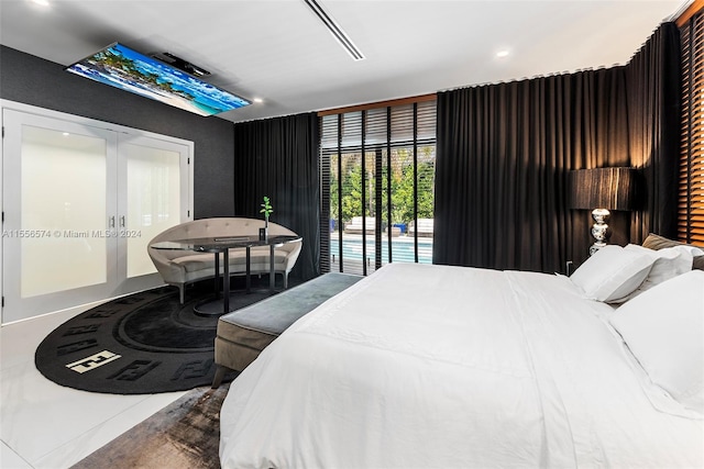 bedroom featuring french doors and tile patterned floors