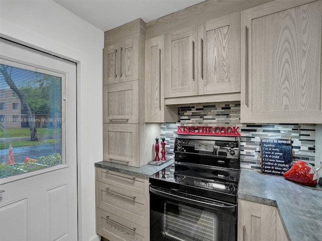 kitchen with tasteful backsplash, electric range, and light brown cabinetry