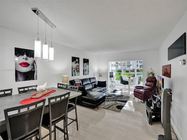 living room with light tile flooring, rail lighting, and a textured ceiling