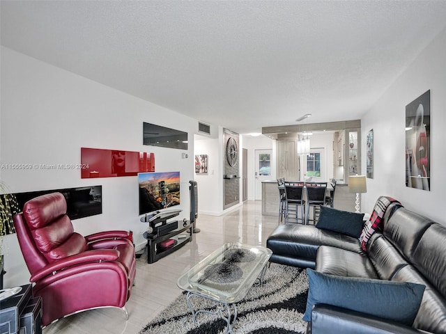 living room with a textured ceiling