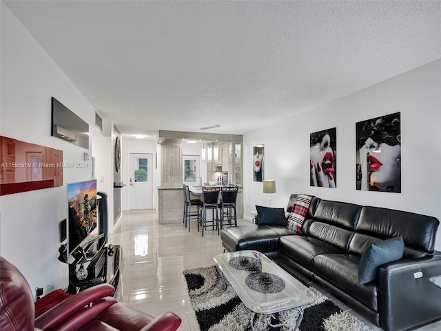 tiled living room with a textured ceiling