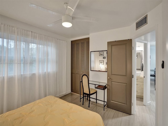 bedroom with a closet, ceiling fan, and light tile floors