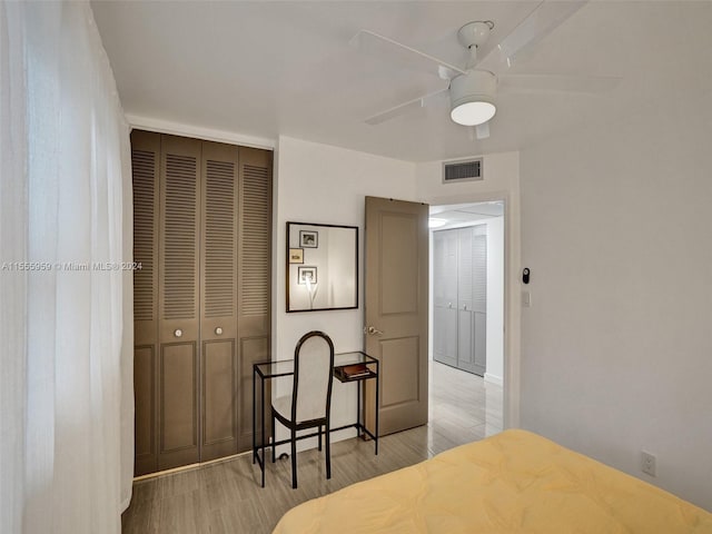 bedroom featuring a closet, ceiling fan, and light wood-type flooring