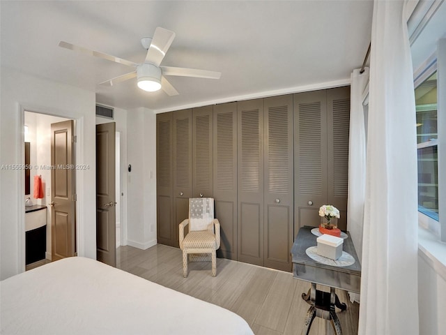 bedroom with light hardwood / wood-style flooring, a closet, and ceiling fan