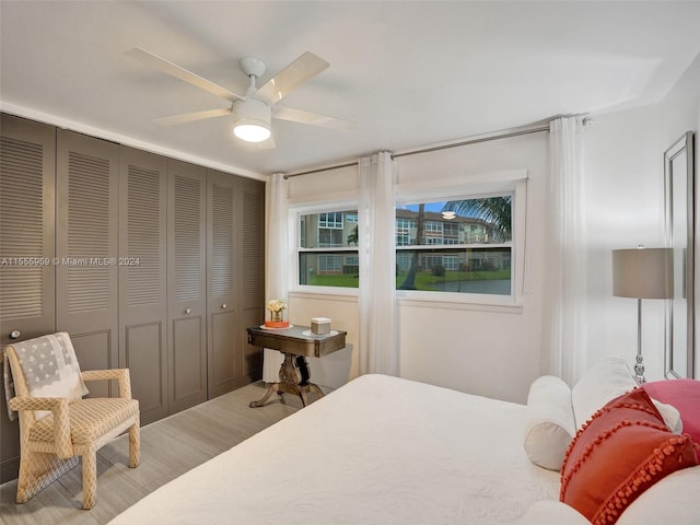 bedroom with light hardwood / wood-style floors and ceiling fan