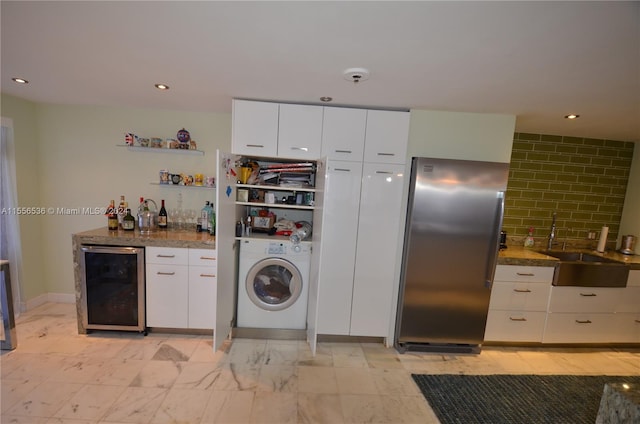 kitchen with washer / clothes dryer, light tile flooring, refrigerator, and wine cooler