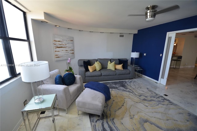 tiled living room featuring ceiling fan