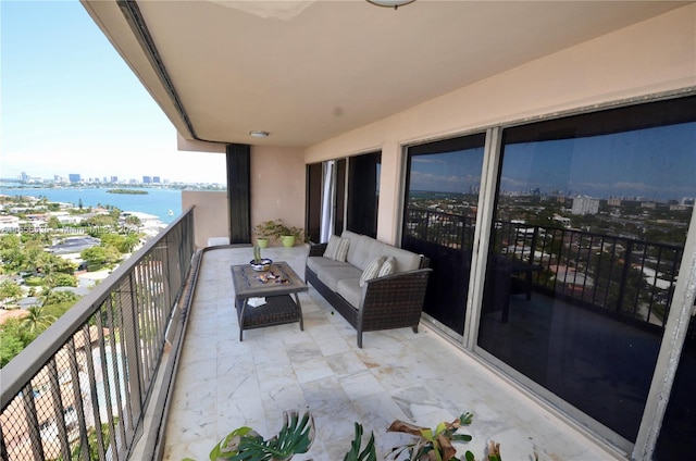 balcony featuring a water view and an outdoor hangout area