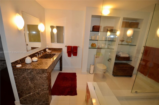 bathroom featuring vanity, walk in shower, tile flooring, and toilet