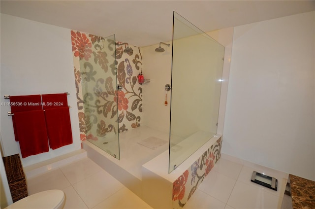 bathroom with toilet, tile floors, and tiled shower