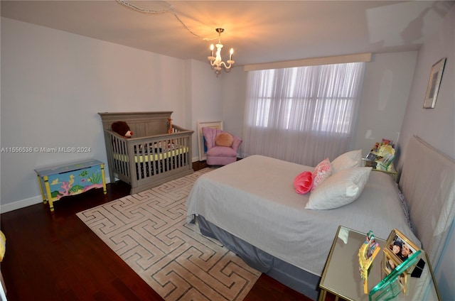 bedroom featuring a chandelier and wood-type flooring