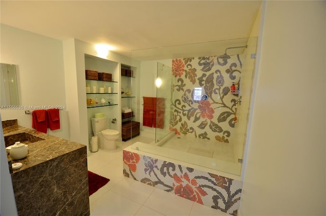 bathroom with a shower, toilet, tile floors, and vanity