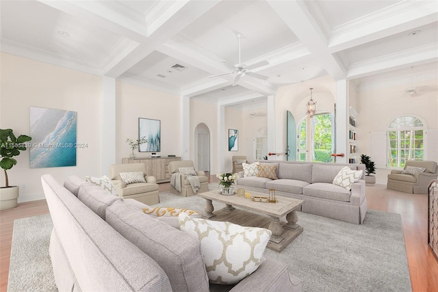 living room with light hardwood / wood-style floors, beam ceiling, coffered ceiling, crown molding, and ceiling fan