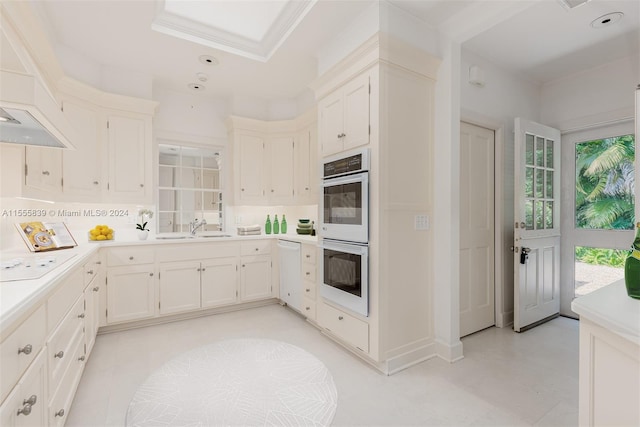 kitchen featuring ornamental molding, white cabinets, sink, and white appliances