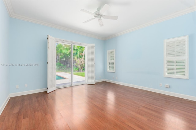 empty room with ceiling fan, hardwood / wood-style floors, and crown molding