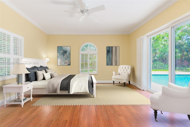 bedroom with light hardwood / wood-style floors, ceiling fan, multiple windows, and access to outside