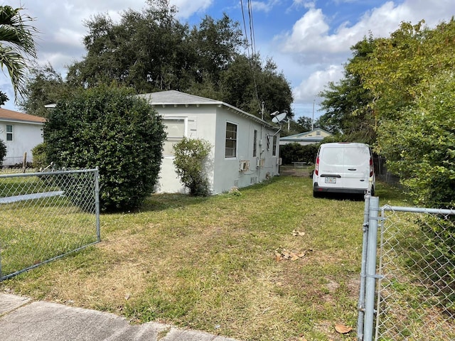 view of side of home with a yard