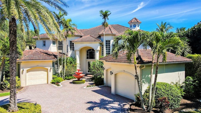 mediterranean / spanish-style house with a garage