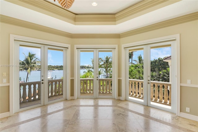 entryway featuring a water view, light tile floors, french doors, and crown molding