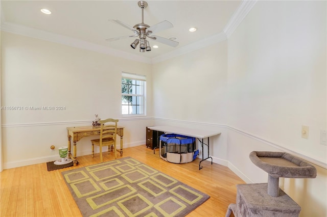 misc room with ornamental molding, light hardwood / wood-style floors, and ceiling fan