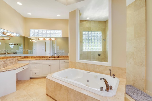 bathroom featuring vanity with extensive cabinet space, tile flooring, double sink, and tiled tub