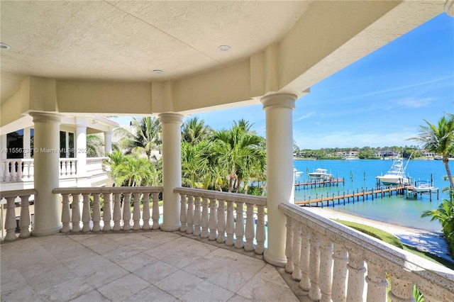 balcony with a dock and a water view