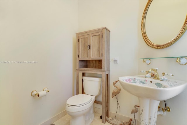 bathroom with tile flooring and toilet